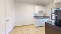 This 520 square foot apartment in Fort Lauderdale offers a well-designed living space on a single floor. The property features one bedroom, measuring 170 square feet, providing ample space for a comfortable sleeping area. The living area is adorned with neutral-toned carpet, creating a cozy atmosphere. Large windows in the bedroom allow natural light to flood the space, enhancing its openness.

The bathroom is equipped with a full-sized bathtub and is fully tiled for easy maintenance. The kitchen, while compact, is efficiently designed with white cabinetry, granite countertops, and modern black appliances including a refrigerator and stove. Tiled flooring in the kitchen area adds a touch of elegance and practicality.

The apartment's layout is thoughtfully planned, with doorways connecting the main living area to the bedroom and bathroom. A closet provides additional storage space. The overall design emphasizes a clean, modern aesthetic with crisp white walls throughout, creating a bright and airy feel in this compact yet functional living space.
