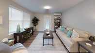 Located at 3 Carriage Walk in Scarborough, Maine, this single-floor residence offers a thoughtfully designed layout with modern finishes and a cohesive neutral color palette that creates a calm, welcoming atmosphere throughout.

The kitchen is a standout feature, outfitted with gray shaker-style cabinetry, granite countertops, stainless steel appliances including a range, microwave, refrigerator, and dishwasher, and a peninsula with bar seating — ideal for casual dining or entertaining. Adjacent to the kitchen is a dedicated dining nook with a window that brings in natural light, providing a cozy space for meals.

The living room is bright and open, with large windows fitted with white blinds, wood-look flooring, and a wall-mounted mini-split system for climate control. A private entry door with a glass panel connects the space to the exterior.

The primary bedroom is generously sized with soft carpeting, ambient lighting, and access to a closet. Additional bedrooms feature windows with garden views, wood-look flooring, and comfortable proportions. The bathroom is clean and modern, with a white vanity, a tub-shower combination, and wood-look flooring that ties seamlessly into the rest of the home's design. Overall, the space presents a polished, move-in-ready aesthetic.