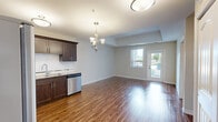 Located at 570 Park Avenue West in Chatham-Kent, Ontario, this well-appointed two-bedroom, one-bathroom unit offers a functional and modern living experience across a single floor. Warm hardwood-style flooring flows throughout the entire space, creating a cohesive and inviting atmosphere.

The open-concept kitchen is a standout feature, showcasing rich dark cabinetry, granite countertops, a white subway tile backsplash, and a full suite of stainless steel appliances including a refrigerator, range, built-in microwave, and dishwasher. A chandelier adds a touch of elegance to the dining area just off the kitchen.

Both bedrooms are comfortably sized with neutral toned walls and the same warm flooring, offering a clean and versatile canvas. The primary bedroom provides a generous footprint suitable for a full bedroom suite. A dedicated closet adds convenient storage to the layout.

The bathroom is finished with a granite-topped vanity and a full soaker tub and shower combination, maintaining the quality finishes found throughout the unit. A separate laundry room houses a full-sized washer and dryer, adding everyday practicality.

The building exterior features attractive stone cladding with landscaped greenery, a bike rack, and accessible walkways, reflecting a well-maintained residential community.