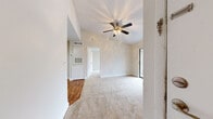 Located at 778 Jimmy Ann Dr in Daytona Beach, FL, this one-bedroom, one-bathroom unit offers a well-organized single-floor layout designed for comfortable everyday living. The living room is a bright, open space featuring vaulted ceilings, a ceiling fan with light fixture, soft carpeting, and a sliding glass door that opens to a balcony with views of lush palm trees and the surrounding landscape, bringing natural light deep into the interior.

The galley-style kitchen is efficiently designed with white shaker cabinetry, light granite-style countertops, hardwood-style flooring, and black appliances including a range and refrigerator. A built-in range hood and a double sink with ample counter space make the kitchen both functional and clean in appearance.

The bedroom is a comfortable, carpeted retreat with a ceiling fan, a large window fitted with vertical blinds that allow for natural light, and two closets providing generous storage. The neutral, warm wall tones throughout the unit create a cohesive and calm ambiance.

The bathroom features a full tub-shower combination with white tile surround and chrome fixtures, maintaining the clean, minimalist aesthetic found throughout the space. The unit's overall design emphasizes simplicity, practicality, and a bright, airy feel suited to the Florida lifestyle.