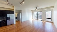 Located at 2824 Emerson Ave S in Minneapolis, this single-floor unit offers a thoughtfully designed layout that balances open living spaces with functional private areas. The main living area features warm hardwood flooring and is bathed in natural light from a sliding glass door that opens to a private balcony, providing views of the surrounding neighborhood. A ceiling fan and track lighting add both practicality and style to the space.

The kitchen is well-appointed with dark espresso cabinetry, granite-style countertops, a glass tile backsplash, and a full suite of stainless steel appliances, including a refrigerator with ice maker, electric range, microwave, and dishwasher. Hardwood floors continue seamlessly from the living area into the kitchen.

A hallway connects the living space to the private areas of the unit. The bedroom features neutral carpet, ample wall space, and receives natural light, creating a calm and comfortable retreat. The bathroom includes a soaking tub with tile surround, a toilet, and a vanity with dark cabinetry and a mirror, finished with clean tile flooring. The overall ambiance is modern, clean, and move-in ready.