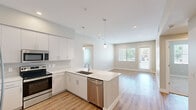 Located at 15024 N 90th St in Scottsdale, AZ, this well-designed 2-bedroom, 2-bathroom residence offers a clean, modern aesthetic across a single-level floor plan. The open-concept kitchen and living area serves as the heart of the home, showcasing white shaker cabinetry extending to the ceiling, a striking quartz waterfall island with an undermount sink, stainless steel appliances including a French door refrigerator, range, microwave, and dishwasher, complemented by a tasteful tile backsplash and warm wood-look plank flooring. Pendant lighting above the island adds a refined touch. The living room flows naturally from the kitchen and features recessed lighting, neutral toned walls, and a glass door providing access to the outdoors and allowing ample natural light. The primary bedroom is a comfortable retreat with plush carpeting, a ceiling fan, and a window with views of the surrounding greenery. Its en-suite bathroom impresses with a lengthy dual-sink vanity topped with quartz counters, a walk-in glass shower, and wood-look flooring. A spacious walk-in closet with built-in shelving and hanging rods provides generous storage. The second bedroom is well-proportioned with soft carpet and natural light. A hallway connects all rooms efficiently, completing this thoughtfully laid-out Scottsdale residence.
