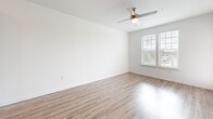 Located at 811 Rosery Rd NW in Largo, FL, this one-bedroom, one-bathroom single-floor home offers a thoughtfully designed open-concept layout. The kitchen is a standout feature, showcasing gray shaker-style cabinetry, a white subway tile backsplash, granite countertops, and a central island with a built-in sink — ideal for both cooking and casual dining. Stainless steel appliances, including a refrigerator, range, and over-the-range microwave, complete the modern kitchen. Wood-look luxury vinyl plank flooring extends through the main living areas, lending warmth and continuity. The open living and dining area receives abundant natural light through large windows and features a ceiling fan overhead. The bedroom is carpeted for comfort, with dual windows offering outdoor views and a ceiling fan for added airflow. A walk-in closet with wire shelving provides generous storage. The bathroom includes a granite-topped vanity with gray cabinetry, a tub-shower combo with white tile surround, and matching wood-look flooring. Two closets across the home ensure ample storage throughout this efficiently designed and stylishly finished residence.