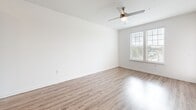 Located at 811 Rosery Rd NW in Largo, FL, this one-bedroom, one-bathroom single-floor home offers a thoughtfully designed open-concept layout. The kitchen is a standout feature, showcasing gray shaker-style cabinetry, a white subway tile backsplash, granite countertops, and a central island with a built-in sink — ideal for both cooking and casual dining. Stainless steel appliances, including a refrigerator, range, and over-the-range microwave, complete the modern kitchen. Wood-look luxury vinyl plank flooring extends through the main living areas, lending warmth and continuity. The open living and dining area receives abundant natural light through large windows and features a ceiling fan overhead. The bedroom is carpeted for comfort, with dual windows offering outdoor views and a ceiling fan for added airflow. A walk-in closet with wire shelving provides generous storage. The bathroom includes a granite-topped vanity with gray cabinetry, a tub-shower combo with white tile surround, and matching wood-look flooring. Two closets across the home ensure ample storage throughout this efficiently designed and stylishly finished residence.