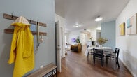 Located at 2551 31st St in Denver, CO, this well-designed 4-bedroom, 3-bathroom unit offers a practical and comfortable single-floor layout. The open-concept living and dining area is anchored by rich hardwood-style flooring, neutral white walls with tasteful accent colors, and ample ceiling-mounted lighting. A private exterior door in the living room adds convenient access and brings in natural light. The kitchen features dark espresso cabinetry, black appliances including a refrigerator, range, and microwave, a tiled backsplash, and an extended white countertop that doubles as a breakfast bar — seamlessly connecting to the dining and living spaces. The four bedrooms are thoughtfully sized, each offering closet storage and clean, bright interiors. The primary bedroom provides a comfortable footprint with room for a full workspace setup. Several bedrooms feature windows with blinds, allowing natural light while maintaining privacy. The three bathrooms are finished with neutral tile flooring, dark wood vanities, white countertops, and shower-tub combinations with curtains. Throughout the unit, the design maintains a clean, modern aesthetic with consistent finishes, making it a well-rounded and functional home in Denver.