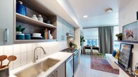Located in Portland's vibrant Northwest District, this thoughtfully designed one-bedroom, one-bathroom residence makes excellent use of its compact footprint. Light hardwood flooring flows throughout, creating a cohesive and airy feel across every room.

The galley-style kitchen is a standout, featuring soft blue-gray cabinetry paired with warm wood open shelving, a white subway tile backsplash, quartz countertops, a deep stainless steel sink, and stainless steel appliances including a gas range. The layout maximizes functionality while maintaining a clean, modern aesthetic.

The living area transitions seamlessly from the kitchen, benefiting from large windows dressed with layered roller shades and patterned drape panels that allow natural light while offering privacy. A built-in display ledge near the entryway adds a personalized touch, ideal for artwork and décor.

The bedroom is generously proportioned, accommodating a full bedroom suite with room to spare. Windows bring in natural light, and the space exudes a calm, comfortable ambiance.

The bathroom is a design highlight, featuring bold blue and gold mountain-motif wallpaper, a floating vanity with a white quartz top, an illuminated mirror, and a stacked in-unit washer and dryer — a highly practical amenity. Every detail reflects a commitment to stylish, efficient urban living.