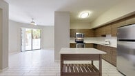 This contemporary 970 square foot apartment in AMLI Dadeland, Miami, offers a blend of style and functionality. The space features three bedrooms, including a 150 square foot primary bedroom, and two full bathrooms. The open-concept layout maximizes the use of space, creating a seamless flow between living areas.

The kitchen is a highlight, boasting modern wood-grain cabinetry, stainless steel appliances, and a convenient kitchen island. Large windows throughout the apartment allow for abundant natural light, enhancing the sense of spaciousness. The floors are a mix of wood-look laminate in the bedrooms and living areas, with elegant tile in the kitchen and bathrooms.

Each bathroom is outfitted with modern fixtures, including a combination tub and shower. The apartment includes ample storage with two closets and built-in shelving. A notable feature is the outdoor access, likely leading to a private balcony or patio.

The unit is equipped with a ceiling fan and recessed lighting, adding both comfort and ambiance. Located on the single floor of this unit, the layout efficiently utilizes the available space, making it an ideal home for those seeking a contemporary urban lifestyle in Miami.