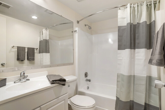 Renovated Package II bath featuring white cabinetry and countertops - Tysons Crossing