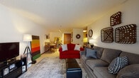 Located at 7515 W Drexel Ave in Franklin, Wisconsin, this single-floor residence offers a well-organized and functional layout designed for comfortable everyday living. The open-concept living and dining area serves as the heart of the home, providing generous space for both relaxing and entertaining. The living room features a textured ceiling, neutral walls, and carpeted flooring, accommodating ample seating and a dedicated media area. A dining space flows naturally from the living room, enhanced by track lighting overhead and a warm, inviting atmosphere. The galley-style kitchen is equipped with rich wood cabinetry, granite-style countertops, a double sink, a dishwasher, and a range, offering efficient use of space with plenty of storage. The two bedrooms are comfortably sized, each featuring carpeted floors, a textured ceiling, and closet storage. Natural light enters through windows dressed with curtains and blinds. The full bathroom includes a vanity with wood cabinetry, a tub-shower combination with a decorative curtain, and tile flooring. Throughout the home, the design emphasizes practicality with a consistent, warm color palette that creates a cohesive and welcoming environment.