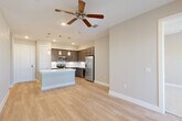 Located at 101 Crawford St in the heart of Houston, TX, this well-appointed 2-bedroom, 2-bathroom residence offers a thoughtfully designed single-level layout with modern finishes throughout. The open-concept living and dining area flows seamlessly into a sleek kitchen, which features dark espresso cabinetry, stainless steel appliances, a central island with a white countertop, and elegant pendant lighting. Light wood-style flooring and ceiling fans enhance the bright, airy ambiance of the main living space, which also benefits from large windows that invite natural light. The bedrooms are carpeted for comfort and offer generous windows with neighborhood views. The primary bedroom includes access to a well-organized walk-in closet with built-in shelving and hanging rods, along with a private en-suite bathroom featuring a dual-sink vanity with dark wood cabinetry and white countertops. The second bathroom offers a full soaking tub with a tiled surround. Additional highlights include a dedicated laundry room with full-size washer and dryer, a pantry, multiple closets for ample storage, and a welcoming entrance. The overall aesthetic is clean, contemporary, and move-in ready.