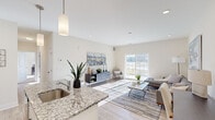 Located at 111 Sunset Cir in Camden, Delaware, this thoughtfully designed 2-bedroom, 2-bathroom single-floor residence offers a comfortable and functional layout with a clean, contemporary aesthetic throughout. The open-concept kitchen and living room serve as the heart of the home, where the kitchen shines with crisp white shaker cabinets, granite countertops, a white subway tile backsplash, and stainless steel appliances. A granite-topped island with a sink provides additional prep space and flows seamlessly into the bright living area. The living room is bathed in natural light from a large sliding glass door that opens to a private patio, offering outdoor views and easy access to fresh air. Recessed lighting and light wood-look flooring complete the space's modern feel. The spacious primary bedroom features plush carpet, a ceiling fan, and multiple windows that allow sunlight to pour in. The second bedroom is equally well-lit and comfortable. Both bathrooms are finished with wood-look flooring, white vanities, and shower-tub combinations. Additional highlights include four closets for generous storage, a dedicated laundry area, and a hallway connecting the private quarters. The overall ambiance is bright, neutral, and move-in ready.