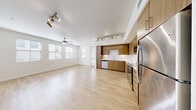 Located in Henderson, NV, this well-designed 3-bedroom, 2-bathroom residence offers a clean, modern aesthetic throughout. The open-concept living, dining, and kitchen area forms the heart of the home, featuring light hardwood-style flooring, large windows that invite abundant natural light, and a ceiling fan. The kitchen is appointed with warm wood cabinetry, a white tile backsplash, stainless steel appliances including a refrigerator, range, microwave, and dishwasher, all illuminated by stylish track lighting. A door from the main living area leads to a private patio, extending the living space outdoors. The hallway connects the main living area to the bedrooms, lined with six closets for generous storage. The three bedrooms feature plush carpeting and windows offering outside views, with the primary bedroom providing a comfortable, spacious retreat. Both bathrooms are finished with wood-style flooring, white walls, and clean chrome fixtures, with a bathtub-shower combination in at least one. An in-unit laundry area adds everyday convenience. The consistent use of light tones and modern finishes throughout creates a bright, cohesive, and inviting atmosphere.