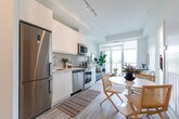 Located at 188 Deerfield Rd in Newmarket, Ontario, this thoughtfully designed 2-bedroom, 1-bathroom unit offers a compact yet functional layout across a single floor. The interior is finished in a clean, contemporary style, with light hardwood-style flooring and crisp white walls that create a bright, airy atmosphere throughout.

The kitchen is efficiently designed with full-height white cabinetry, a light grey subway tile backsplash, marble-look countertops, and a full suite of stainless steel appliances including a refrigerator, dishwasher, and range. A hallway connects the main living areas to the bedrooms, maintaining a logical and practical flow through the unit.

The primary bedroom is a comfortable retreat, featuring floor-to-ceiling windows that flood the space with natural light and offer views of the surrounding neighbourhood. It also includes a dedicated walk-in closet. The second bedroom is similarly bright, with a large window and a built-in sliding door closet. Both rooms share a well-appointed full bathroom, complete with a soaker tub and shower combination, tiled surround in warm neutral tones, a white vanity with undermount sink, and light wood-style flooring. A dedicated closet provides additional storage within the unit.