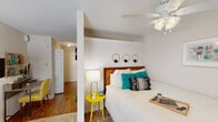 This single-floor studio in Metairie, Louisiana, offers a thoughtfully organized open layout that efficiently combines living, sleeping, and working areas. A structural column naturally divides the sleeping zone from the living space, providing a sense of separation without sacrificing openness. The sleeping area features a ceiling fan with light fixture and crown molding details, while hardwood-style flooring runs through the entry, kitchen, and hallway areas, transitioning to carpet in the living and sleeping zones.

The living area is brightened by a window with blinds and drape panels, allowing natural light to fill the space. A wall-mounted HVAC unit provides climate control. The kitchen is equipped with light wood cabinetry, a coil-top electric range, a stainless steel sink with ample counter space, and a microwave. A hallway connects the main living areas to the bathroom, which includes a shower/tub combination, a vanity with light wood cabinetry, and wood-style flooring. In-unit laundry is also accessible via the hallway, adding everyday convenience. The entry corridor features textured walls, offering a welcoming transition into the open living space.