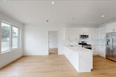 Located at 3309 Liberty Avenue in North Bergen, NJ, this modern 2-bedroom, 3-bathroom residence offers a thoughtfully designed single-floor layout with a clean, contemporary aesthetic throughout. Light hardwood flooring and crisp white walls create a bright, cohesive atmosphere across all rooms.

The open-concept living, dining, and kitchen area serves as the heart of the home. The kitchen is outfitted with sleek white cabinetry extending to the ceiling, a striking marble-veined quartz peninsula, stainless steel appliances including a gas range, built-in microwave, dishwasher, and French door refrigerator, all complemented by recessed lighting above.

The living area is generously proportioned, featuring large windows that flood the space with natural light and a door providing direct access to a spacious private rooftop terrace with open sky views and lush tree-lined surroundings.

Both bedrooms are well-sized and sun-filled, each with large windows framing green outdoor views and individual climate control units. The primary bedroom includes a dedicated walk-in closet with full-length hanging rails. Three elegantly finished bathrooms feature marble-style tile, soaking tubs, glass shower enclosures, floating vanities with quartz countertops, and mirrored medicine cabinets. A dedicated laundry area and three closets round out this well-appointed home.