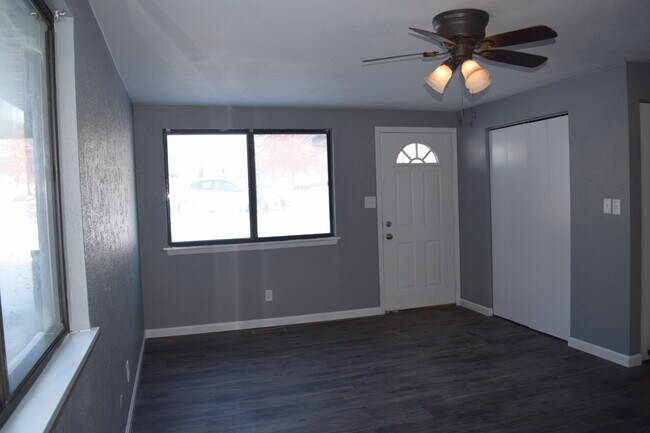 Spacious living room with large windows letting in natural light. - 108 Wood Ct