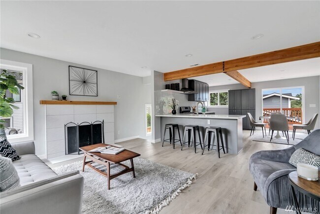 Living room with 55 inch TV, large windows - 8511 2nd Ave NE