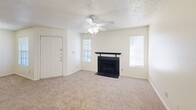 Located in Waco, TX, this single-story, 2-bedroom, 4-bathroom home offers a practical and comfortable layout across one thoughtfully arranged floor. The living room serves as the heart of the home, featuring plush carpet, a ceiling fan with light fixture, a classic tiled fireplace, and sliding glass door access to the outdoors, allowing natural light to fill the space. The kitchen is well-appointed with warm honey-toned wood cabinetry, white appliances including a coil-top range and refrigerator, a double basin sink, and light countertops. A peninsula adds prep space and defines the transition between the kitchen and living areas, while wood-look flooring anchors the functional workspace. Both bedrooms are carpeted and equipped with ceiling fans. The primary bedroom offers a generous footprint with ample natural light from a window with blinds. Four closets throughout the home provide abundant storage, including walk-in closets with wire shelving systems. The four bathrooms each feature tub-shower combinations with tiled surrounds and chrome fixtures. A dedicated laundry area and hallway complete the layout, making this a well-rounded, single-level home suited for everyday living.