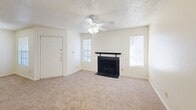 Located in Waco, TX, this single-story, 2-bedroom, 4-bathroom home offers a practical and comfortable layout across one thoughtfully arranged floor. The living room serves as the heart of the home, featuring plush carpet, a ceiling fan with light fixture, a classic tiled fireplace, and sliding glass door access to the outdoors, allowing natural light to fill the space. The kitchen is well-appointed with warm honey-toned wood cabinetry, white appliances including a coil-top range and refrigerator, a double basin sink, and light countertops. A peninsula adds prep space and defines the transition between the kitchen and living areas, while wood-look flooring anchors the functional workspace. Both bedrooms are carpeted and equipped with ceiling fans. The primary bedroom offers a generous footprint with ample natural light from a window with blinds. Four closets throughout the home provide abundant storage, including walk-in closets with wire shelving systems. The four bathrooms each feature tub-shower combinations with tiled surrounds and chrome fixtures. A dedicated laundry area and hallway complete the layout, making this a well-rounded, single-level home suited for everyday living.