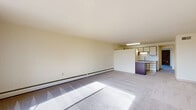 Located at 2550 Second St in Cuyahoga Falls, Ohio, this one-bedroom, one-bathroom unit offers a well-organized single-floor layout designed for comfortable everyday living. The open-concept living and kitchen area forms the heart of the unit, where the living room features plush carpeting, baseboard heating, and a striking exposed brick accent wall framing a large sliding glass door that opens to a private balcony with pleasant outdoor views and abundant natural light. The kitchen is thoughtfully equipped with granite countertops, a subway tile backsplash, white cabinetry, white appliances including a range and refrigerator, tile flooring, and a peninsula with dark cabinetry that provides additional prep and storage space. The generously sized bedroom is carpeted and includes an impressive four closets, offering exceptional storage capacity. The bathroom features a full vanity with under-cabinet storage, a tiled tub-shower combination with a light blue tub, and a skylight that introduces natural light. Baseboard heating is present throughout the unit, ensuring consistent warmth. The neutral color palette and clean design create a bright, cohesive ambiance throughout this practical and well-appointed Cuyahoga Falls residence.