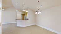 Located at 121 Margie Dr in Warner Robins, GA, this single-story, 3-bedroom, 2-bathroom home offers a well-designed layout with comfortable living spaces throughout. The open living area is a standout feature, boasting vaulted ceilings and ceiling fans that enhance the sense of space and airflow. Neutral beige carpeting and warm wall tones create a cohesive, inviting ambiance throughout. The kitchen is efficiently arranged with white cabinetry, a tile backsplash, and a peninsula counter topped with dark granite, seamlessly connecting to the living room for an open-concept feel. The primary bedroom is generously sized, complete with a ceiling fan and a walk-in closet featuring built-in wire shelving for ample organization. Its en-suite bathroom includes a soaking tub, a separate glass-enclosed shower, and a frosted glass window that allows natural light while maintaining privacy. The additional bedrooms are well-proportioned, each with ceiling fans and carpeted floors. The second bathroom features a tiled tub-shower combination. Multiple closets are found throughout the home, providing practical storage solutions. The layout connects efficiently via two hallways, ensuring smooth flow between all rooms.