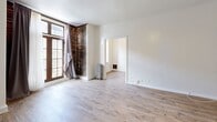 Located at 601 N Rossmore Ave in the heart of Los Angeles, this single-floor unit blends vintage character with modern updates across a well-organized layout. The living room is a standout space, featuring exposed brick accent walls, large French-style windows that invite generous natural light, light wood-look flooring, and a ceiling fan with integrated lighting. A cast-iron radiator and built-in shelving add both function and charm to the room.

The galley kitchen is efficiently designed with white shaker cabinetry, light wood-look flooring, a stainless steel Frigidaire refrigerator, a gas range, and a single-basin sink — offering all the essentials in a clean, streamlined layout.

Two bathrooms serve the unit, with at least one showcasing classic white subway tile surrounding a full bathtub, hex-tile flooring with a decorative blue floral mosaic inlay, a window for natural ventilation, and a white vanity — a nod to timeless design.

A hallway connects the rooms, contributing to the efficient flow of the space. Throughout, the crisp white walls contrast beautifully with the warm flooring and exposed brick, creating a cohesive blend of historic character and contemporary comfort in one of Los Angeles' well-established neighborhoods.