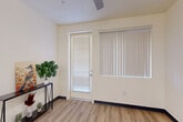 Located at 4910 W Glenn Dr in Glendale, Arizona, this one-bedroom, one-bathroom unit offers a practical and well-appointed single-floor layout. The open-concept living and kitchen area is finished with light wood-style vinyl flooring and neutral cream walls, creating a bright and cohesive atmosphere. A ceiling fan in the living area complements the natural light that flows in through a glass door and large window fitted with vertical blinds, offering access and views to the outdoors.

The kitchen is thoughtfully designed with gray shaker-style cabinetry, white quartz countertops, and a peninsula that provides additional prep space and a casual dining area. White appliances, including a refrigerator, electric range, and microwave, are complemented by a pendant light above the peninsula and recessed lighting overhead.

The bedroom features wall-to-wall carpet, a ceiling fan, a sliding closet, and a window with vertical blinds that allows natural light into the space. Its layout offers a comfortable and private retreat.

The bathroom is finished with the same light wood-style flooring found throughout the unit, and includes a full-size tub and shower combination, a toilet, and a wide vanity with a white countertop and a large mirror. The gray cabinetry in the bathroom mirrors the kitchen's design, tying the unit together with a consistent aesthetic.