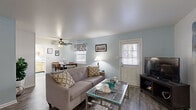 Located at 626 Chelsea Place in Newport News, Virginia, this well-appointed 2-bedroom, 1-bathroom single-story home offers a thoughtfully designed layout that maximizes comfort and functionality. The inviting living room features durable wood-look flooring, soft blue-gray accent walls, multiple windows with natural light, a ceiling fan, and a front entry door — creating a welcoming and airy atmosphere. The space flows naturally into a dining area, making it ideal for everyday living and entertaining. The kitchen is equipped with light maple cabinetry, light-toned countertops, a full suite of white appliances including a dishwasher, and wood-look flooring that ties the common areas together cohesively. The spacious primary bedroom is carpeted and features vaulted-style ceilings and two sets of louvered bifold closet doors, offering generous storage. The second bedroom is also carpeted with neutral walls and a window for natural light. The full bathroom includes a clean white tiled tub-shower combination with chrome fixtures. Throughout the home, a neutral and light color palette creates a calm, welcoming ambiance well-suited for comfortable everyday living in Newport News.