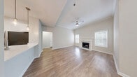 Located at 7150 W Peachtree Dunwoody Rd NE in Atlanta, GA, this well-appointed single-floor residence offers three bedrooms, four bathrooms, and a thoughtfully designed layout that maximizes functionality throughout. Light-toned hardwood-style flooring runs continuously through the home, complementing the neutral palette of warm beige and crisp white walls.

The galley-style kitchen is outfitted with white shaker cabinetry, white quartz countertops, a classic subway tile backsplash, and a full suite of stainless steel appliances including an electric range, over-the-range microwave, refrigerator, and dishwasher. The kitchen connects seamlessly to the rest of the living areas via a central hallway.

The living room is a standout space, featuring crown molding, a ceiling fan, and a marble-surround fireplace flanked by windows that invite natural light. The spacious primary bedroom includes crown molding, a ceiling fan, and direct access to a dedicated closet with wire shelving for organized storage. Additional bedrooms are bright and well-sized, each equipped with ceiling fans and generous window coverage. The four bathrooms are clean and functional, finished consistently with the home's modern aesthetic. A connecting hallway with six-panel doors ties the layout together efficiently.