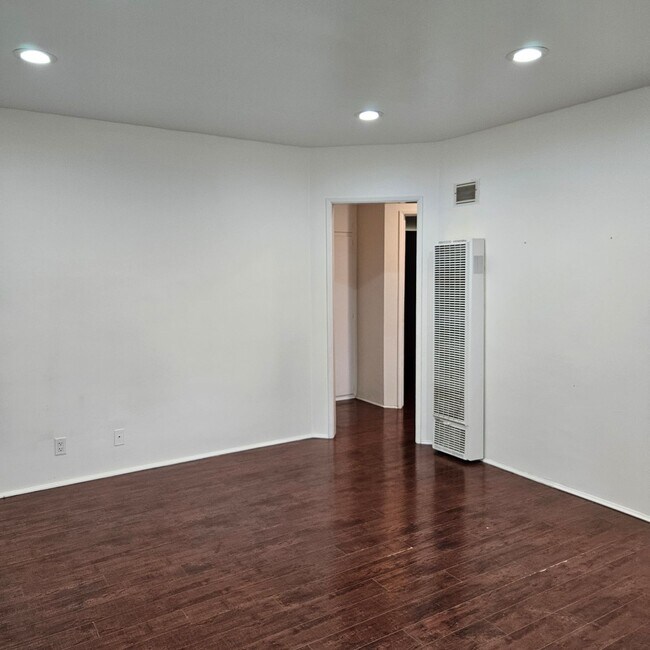 Living area with wall heater - 7908 Friends Ave