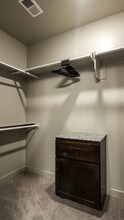Walk in closet features dirty laundry hamper - Bowman Pointe