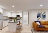 Located at 2531 W Rumble Rd in Modesto, CA, this well-designed one-bedroom, one-bathroom unit offers a thoughtfully laid-out single-floor plan with modern finishes throughout. Light wood-style flooring runs continuously across the space, creating a cohesive and airy feel.

The open-concept kitchen and living area serves as the heart of the home. The kitchen is equipped with white shaker-style cabinetry, granite-look countertops, stainless steel appliances including a range, microwave, and dishwasher, and a center island with bar seating — ideal for casual dining. The living area is generously proportioned, featuring recessed lighting and a glass door that opens to a private outdoor patio, allowing natural light to flow freely into the space.

The bedroom offers a comfortable retreat with windows providing natural light and outdoor views. A dedicated closet provides convenient storage. The full bathroom features white shaker vanity cabinetry with granite-look countertops, a tub-and-shower combination adorned with marble-style surround tile, and recessed lighting.

The exterior of the building presents a contemporary multi-story stucco facade with landscaped grounds. This unit also includes a private gated patio entry, adding an additional layer of functionality and charm to the overall living experience.