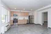 Located in the heart of downtown Boise at 620 W Front St, this modern single-floor residence offers a thoughtfully designed open-concept layout with clean contemporary finishes throughout. Light wood-tone luxury vinyl plank flooring flows seamlessly across the entire unit, creating a cohesive and warm aesthetic.

The entry hallway, accented by arched mirrors, leads directly into the main living area. The living room is bright and inviting, featuring a large window that frames views of the surrounding Boise cityscape and allows abundant natural light to fill the space.

The kitchen is well-appointed with light wood cabinetry extending to the ceiling for ample storage, white quartz countertops, a white subway tile backsplash, and a full suite of stainless steel appliances including a refrigerator, dishwasher, electric range, and over-the-range microwave. A dedicated dining area provides a comfortable space for meals.

The bedroom offers a tranquil retreat with a sliding-door closet providing generous storage. The bathroom features a wood-toned vanity with a white countertop, a combination tub and shower, and wood-look flooring that carries the unit's design language throughout. The overall ambiance is modern, functional, and move-in ready.