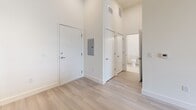 This contemporary 1-bedroom apartment in Tampa, FL offers 530 square feet of efficiently designed living space. The open floor plan maximizes the use of space, creating a seamless flow between living areas. The kitchen is a standout feature, boasting modern wood-grain cabinetry, granite countertops, and stainless steel appliances including a built-in microwave and full-size refrigerator.

The bedroom, measuring 150 square feet, is generously sized for the apartment and features large windows that flood the space with natural light. The bathroom is well-appointed with a modern vanity, granite countertop, and a combination tub-shower unit. Light-colored tile in the bathroom complements the overall bright and airy feel of the apartment.

Throughout the unit, neutral-toned walls and light wood-look flooring create a fresh, contemporary ambiance. The entryway leads directly into the main living area, showcasing the open concept design. High ceilings add to the sense of spaciousness, while recessed lighting provides a modern touch. This apartment is ideal for those seeking a stylish, low-maintenance living space in an urban setting.