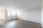 This contemporary 3-bedroom, 2-bathroom apartment in Kitchener, Ontario offers 820 square feet of efficiently designed living space. The interior showcases a fresh, neutral color palette with crisp white walls and modern wood-look flooring throughout, creating a cohesive and inviting atmosphere.

The kitchen features sleek white cabinetry with long, brushed nickel handles, complemented by a pristine white countertop and a practical double-basin stainless steel sink. A subway tile backsplash adds a touch of classic style to the space.

The primary bedroom, measuring 170 square feet, provides ample space and is brightened by a large window allowing natural light to flood in. Built-in closets with white paneled doors offer convenient storage solutions.

Both bathrooms have been thoughtfully updated with modern fixtures. One bathroom showcases a glass-enclosed shower with gleaming white tiles, while the other features a clean, white vanity and toilet arrangement.

The living areas are spacious and well-lit, with large windows providing views of the surrounding greenery. Crown molding adds a refined touch to the ceiling lines. The open floor plan allows for flexible furniture arrangements and easy flow between spaces.

This apartment combines practical living with contemporary style, offering a comfortable and low-maintenance home in a desirable Kitchener location.