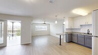 Located at 448 W Georgia St in Tallahassee, FL, this well-appointed 3-bedroom, 2-bathroom residence offers a thoughtfully designed single-floor layout with generous living space. The open-concept kitchen and living room serves as the heart of the home, featuring light wood-look flooring, a ceiling fan, and a bright window with blinds. The kitchen is outfitted with two-tone cabinetry — white upper cabinets and gray lower cabinets — granite countertops, a subway tile backsplash, a peninsula with a bistro-style countertop, pendant lighting, and a full suite of stainless steel appliances including a refrigerator, electric range, microwave, and dishwasher. The three bedrooms are well-sized, with the spacious primary bedroom featuring multiple windows and a ceiling fan. Each bedroom includes closet storage, and additional built-in shelving is available in a dedicated closet space. Both bathrooms are finished with tile flooring, granite-topped blue-gray vanities, large mirrors, and stylish lighting fixtures, with one bathroom featuring a tiled tub-shower combination. The unit also includes a balcony, providing outdoor access, and light wood-look flooring runs consistently throughout the living areas and bedrooms, creating a clean, cohesive aesthetic.
