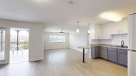 Located at 448 W Georgia St in Tallahassee, FL, this well-appointed 3-bedroom, 2-bathroom residence offers a thoughtfully designed single-floor layout with generous living space. The open-concept kitchen and living room serves as the heart of the home, featuring light wood-look flooring, a ceiling fan, and a bright window with blinds. The kitchen is outfitted with two-tone cabinetry — white upper cabinets and gray lower cabinets — granite countertops, a subway tile backsplash, a peninsula with a bistro-style countertop, pendant lighting, and a full suite of stainless steel appliances including a refrigerator, electric range, microwave, and dishwasher. The three bedrooms are well-sized, with the spacious primary bedroom featuring multiple windows and a ceiling fan. Each bedroom includes closet storage, and additional built-in shelving is available in a dedicated closet space. Both bathrooms are finished with tile flooring, granite-topped blue-gray vanities, large mirrors, and stylish lighting fixtures, with one bathroom featuring a tiled tub-shower combination. The unit also includes a balcony, providing outdoor access, and light wood-look flooring runs consistently throughout the living areas and bedrooms, creating a clean, cohesive aesthetic.