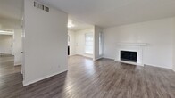 Located at 2300 Richmond Dr in Arlington, TX, this single-story home offers six bedrooms and two full bathrooms across a well-organized floor plan. The living room makes a strong first impression with durable hardwood-style plank flooring, neutral walls, and a classic fireplace with a white mantle — an ideal gathering space filled with natural light from a front-facing window. The galley-style kitchen is efficiently designed with gray cabinetry, dark countertops, a double stainless steel sink, and stainless steel appliances including a refrigerator and range. All six bedrooms feature plush wall-to-wall carpeting and large windows that allow ample natural light to filter in, creating comfortable and versatile spaces. The primary bedroom is generously sized and includes access to a dedicated closet and an en-suite bathroom. Both bathrooms are finished with gray vanity cabinetry, dark countertops, and tub-shower combinations with tile surrounds, maintaining a consistent and clean aesthetic throughout. Three hallways connect the various rooms, ensuring smooth circulation across the layout. The home's neutral color palette, functional design, and variety of rooms make it a highly adaptable space suited for a range of living arrangements.