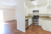 Located at 8888 Citrus Ave in Fontana, California, this two-story residence offers a well-organized layout with a clean, neutral palette throughout. The main living area on the lower floor features rich wood-style flooring that extends through the open space, with a ceiling fan overhead and a staircase leading to the upper level. Natural light filters in through vertical blinds, creating a bright and welcoming atmosphere.

The kitchen is thoughtfully designed with white cabinetry, granite-style countertops, and a full suite of stainless steel appliances including a range, dishwasher, and hood vent. A pass-through window connects the kitchen to the adjacent living space, enhancing the open flow between rooms.

Upstairs, the carpeted bedrooms offer a quiet, comfortable retreat, each benefiting from windows that allow natural light and views of the surrounding greenery. The textured ceilings and soft tones lend a consistent, cohesive feel throughout both floors.

The bathroom is finished with a wide vanity topped with a light quartz-style countertop, dual sinks, and large mirrors. An adjacent walk-in closet provides generous storage. Throughout the home, the combination of wood-style flooring in common areas and plush carpet in bedrooms creates a practical and comfortable living environment.