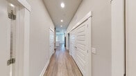 Located in Franklin, TN, this well-appointed 3-bedroom, 3-bathroom residence offers a thoughtfully designed single-level layout. The open-concept kitchen serves as the heart of the home, featuring white shaker cabinetry, a large center island with a white quartz countertop and undermount sink, stainless steel appliances, a tile backsplash, and pendant lighting. A sliding barn door adds a charming architectural touch. The kitchen flows seamlessly into the living area, which is finished with wood-style plank flooring, recessed lighting, and a ceiling fan. Large windows frame picturesque views of a landscaped pond and rolling greenery, filling the space with natural light. A balcony extends the living space outdoors, offering sweeping views of the scenic surroundings and distant hills. The primary bedroom is generously sized, featuring hardwood-style flooring, multiple windows, and a ceiling fan. Its en-suite bathroom is elegantly finished with large-format tile, a glass-enclosed walk-in shower, a soaking tub, and a white vanity. Secondary bedrooms are carpeted and well-lit with natural light. Additional bathrooms mirror the refined tile work and clean finishes found throughout. Two closets provide ample storage, completing this polished and functional residence.