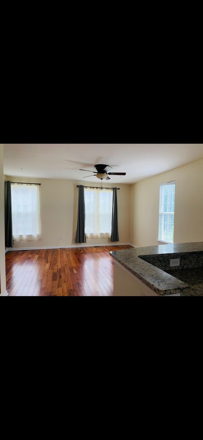 L shaped kitchen looking over large living area - 210 Foxtail Way