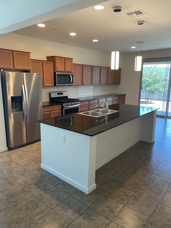 Kitchen with stainless steel appliances and plenty of cabinet space. - 1983 North 214th Dr