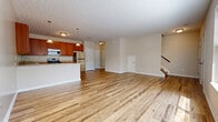 Located at 125 Water St in Milford, Ohio, this two-story home offers four bedrooms, three bathrooms, and a well-organized layout spread across two floors. The main level features an open-concept living and kitchen area finished with light hardwood flooring that enhances the sense of space and brightness. The kitchen is equipped with stainless steel appliances — including a refrigerator, range, and microwave — warm-toned wood cabinetry, and light granite-style countertops, with pendant lighting adding a polished touch. A textured ceiling carries throughout the main level, complementing the neutral wall tones. A staircase leads to the upper floor, which is the larger of the two levels and houses the majority of the bedrooms. The generously sized primary bedroom features plush carpeting and includes access to a walk-in closet outfitted with wire shelving and basket storage for organizational convenience. The additional bedrooms are also carpeted, offering a comfortable, quiet atmosphere. The bathrooms are finished with wood-tone vanities and granite-style countertops, consistent with the home's overall aesthetic. An attached garage with a motorized door opener provides secure, convenient parking. With four closets distributed throughout, the home offers ample storage for everyday living.