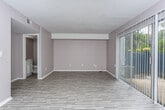 Located at 2415 Brierwood Dr in Albany, Georgia, this two-floor residence offers a clean, functional layout with a neutral color palette throughout. Light vinyl plank flooring runs through the main living areas, bedrooms, and hallways, providing a cohesive and low-maintenance finish across both levels.

The kitchen is well-appointed with ample white cabinetry extending to the upper walls, generous countertop space, a double stainless steel sink, and room for a full suite of appliances. A window brings in natural light, enhancing the bright, airy feel of the space.

The living area features a wide sliding glass door dressed with vertical blinds, allowing for both natural light and outdoor access. Bedrooms are comfortably sized, each with windows fitted with blinds that offer natural light and privacy. The rooms feature the same light LVP flooring and neutral taupe walls, creating a calm and versatile environment.

Two full bathrooms each include a single-sink vanity with under-cabinet storage, a toilet, and a tub-shower combination. The bathrooms are finished in white, contributing to a clean and functional aesthetic.

The textured ceilings visible in several rooms add a subtle traditional character to the interior, while the overall design remains straightforward and move-in ready.