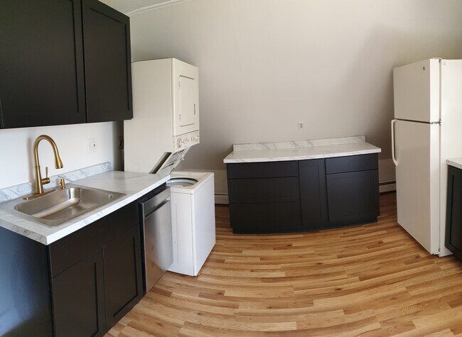 Enjoy the ease of in-unit washer and dryer tucked right into your newly updated kitchen - 412 Morris Ave