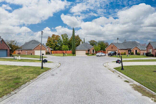 A row of brick homes sits along a quiet cul-de-sac in central Youngsville, Louisiana.
