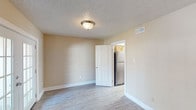 This well-appointed three-bedroom, two-and-a-half-bathroom townhome offers a comfortable and functional layout spread across two floors. Throughout the home, warm neutral-toned walls are complemented by light hardwood-style flooring and crisp white trim, creating a cohesive and inviting atmosphere.

The main living area is anchored by elegant French doors that flood the space with natural light and provide access to the outdoors. A ceiling fan overhead and an additional window enhance air circulation and brightness in this open, airy room.

The galley-style kitchen is efficiently designed with warm oak cabinetry, light granite-look countertops, a stainless steel refrigerator, gas range, and dishwasher. A doorway from the kitchen connects seamlessly to the main living area, supporting an easy flow throughout the home.

Each of the three bedrooms features hardwood-style flooring, ceiling fans, and textured ceilings. Two of the bedrooms include closets with built-in hanging rods, offering practical storage. The bedrooms are well-lit, with windows providing natural light throughout the day.

The bathrooms are finished with warm wood vanities, light countertops, and mirror-lit fixtures, providing a clean and functional design. A half bath offers added convenience for guests. Consistent finishes and thoughtful details make this townhome a practical and comfortable residence.
