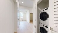 This contemporary apartment in Kelowna offers 53 square meters of thoughtfully designed living space. The layout comprises two bedrooms, one bathroom, a kitchen, living room, hallway, and closet, all arranged on a single floor. The primary bedroom measures a comfortable 9 square meters, providing ample space for rest and relaxation.

The heart of the home is the modern kitchen, featuring a sleek design with two-tone cabinetry - white upper cabinets and grey lower units. Stainless steel appliances, including a refrigerator, stove, microwave, and dishwasher, complement the marble-look backsplash, creating a stylish and functional cooking space.

Throughout the apartment, light-toned hardwood flooring adds warmth and continuity. Large windows in the bedrooms and living areas flood the space with natural light, enhancing the sense of openness. The bathroom showcases a clean, all-white design with a bathtub-shower combination and modern fixtures.

Storage solutions include a walk-in closet with wire shelving, offering practical organization options. The apartment's neutral color palette, characterized by white walls and ceilings, provides a blank canvas for personalization while maintaining a bright, airy atmosphere.

Located at 500 Asher Rd in Kelowna, this apartment combines contemporary design with practical living, perfect for those seeking a modern urban lifestyle in British Columbia.