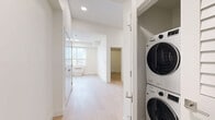 This contemporary apartment in Kelowna offers 53 square meters of thoughtfully designed living space. The layout comprises two bedrooms, one bathroom, a kitchen, living room, hallway, and closet, all arranged on a single floor. The primary bedroom measures a comfortable 9 square meters, providing ample space for rest and relaxation.

The heart of the home is the modern kitchen, featuring a sleek design with two-tone cabinetry - white upper cabinets and grey lower units. Stainless steel appliances, including a refrigerator, stove, microwave, and dishwasher, complement the marble-look backsplash, creating a stylish and functional cooking space.

Throughout the apartment, light-toned hardwood flooring adds warmth and continuity. Large windows in the bedrooms and living areas flood the space with natural light, enhancing the sense of openness. The bathroom showcases a clean, all-white design with a bathtub-shower combination and modern fixtures.

Storage solutions include a walk-in closet with wire shelving, offering practical organization options. The apartment's neutral color palette, characterized by white walls and ceilings, provides a blank canvas for personalization while maintaining a bright, airy atmosphere.

Located at 500 Asher Rd in Kelowna, this apartment combines contemporary design with practical living, perfect for those seeking a modern urban lifestyle in British Columbia.