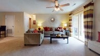 This single-story residence offers a thoughtfully designed layout with multiple bedrooms, two full bathrooms, a galley-style kitchen, and a generous living area. The kitchen features light wood cabinetry, dark granite-style countertops, tile flooring, and black stainless appliances including a range and built-in microwave. A dedicated laundry closet with wire shelving is conveniently accessible directly from the kitchen.

The living room is carpeted and bright, with a ceiling fan, neutral walls, and sliding glass door access to an outdoor patio. The open flow connects easily to the dining area and bedrooms. Each bedroom is carpeted and well-sized; one features a built-in window seat with natural light, while another includes a dedicated workspace and an accent wall. One bedroom offers a private en-suite bathroom, and a second full bathroom serves the remaining rooms.

Both bathrooms include light wood vanities with white countertops, tile flooring, and tub-shower combinations. Throughout the residence, a consistent warm, neutral color palette and textured ceilings contribute to a cohesive and comfortable ambiance.